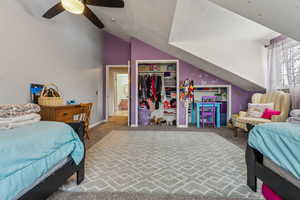 Bedroom with carpet flooring, ceiling fan, lofted ceiling, and a closet