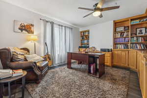 Office area featuring ceiling fan and dark hardwood / wood-style floors