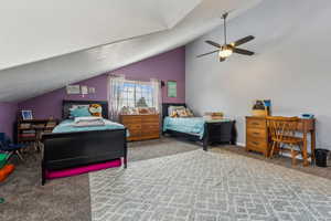 Bedroom with carpet flooring, vaulted ceiling, and ceiling fan