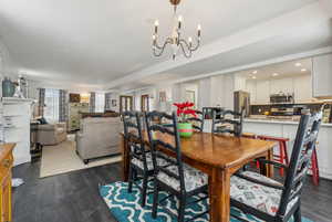 Dining area featuring dark wood-type flooring and a chandelier