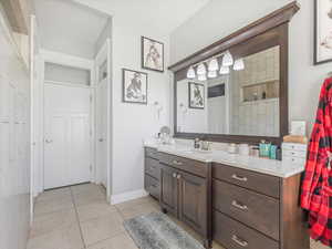 Bathroom featuring tile patterned flooring and vanity