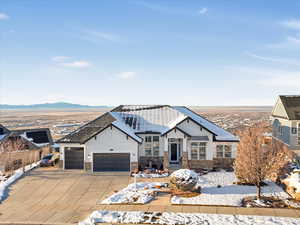 View of front of property with a mountain view and a garage