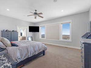 Carpeted bedroom with ceiling fan