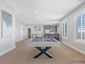 Playroom featuring light colored carpet and billiards