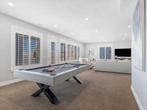 Playroom with light colored carpet and billiards