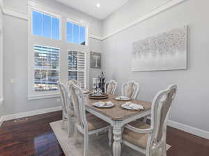 Dining space with dark hardwood / wood-style floors