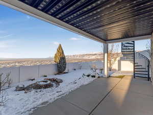 Snow covered patio featuring a fire pit