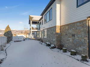 Snowy yard with a balcony