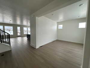 Unfurnished room featuring a textured ceiling and hardwood / wood-style flooring