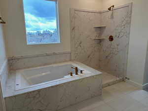 Bathroom with independent shower and bath and tile patterned floors