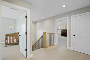 Corridor with light colored carpet