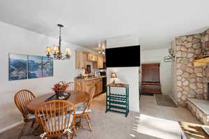 Dining area featuring sink, a chandelier, and light tile patterned floors