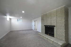 Unfurnished living room with a fireplace and carpet flooring