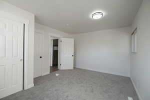 Unfurnished bedroom with carpet flooring