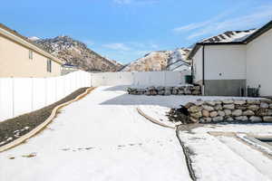 Yard covered in snow with a mountain view