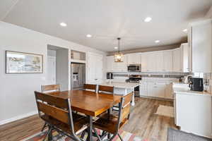 Dining room with light hardwood / wood-style floors and sink