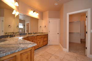 Bathroom with vanity and tile patterned flooring