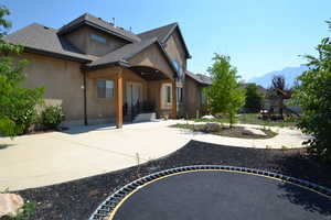 Rear view of property with a patio, a playground, and a mountain view