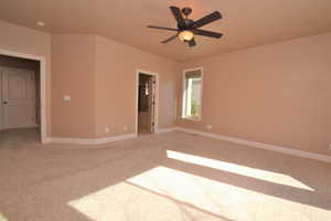 Spare room featuring ceiling fan and light colored carpet