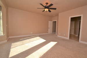 Unfurnished bedroom featuring ceiling fan and light carpet