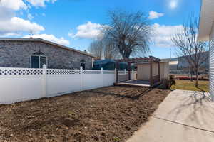 View of yard featuring a deck and a pergola