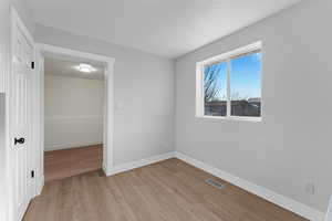 Unfurnished room with light hardwood / wood-style flooring