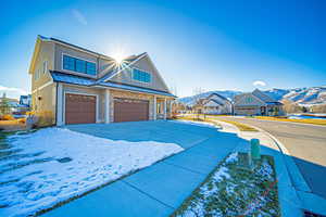 View of front of house with a mountain view and a garage