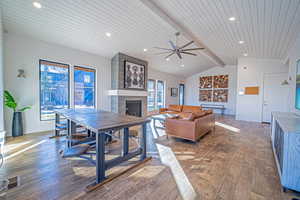 Dining room with hardwood / wood-style flooring, a healthy amount of sunlight, and wood ceiling