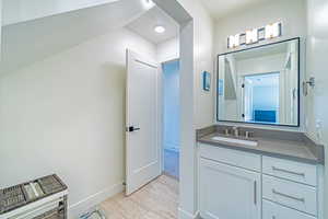 Bathroom with vanity and hardwood / wood-style flooring