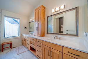 Bathroom with vanity and vaulted ceiling