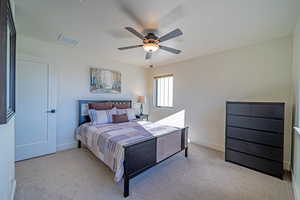 Bedroom with light carpet and ceiling fan