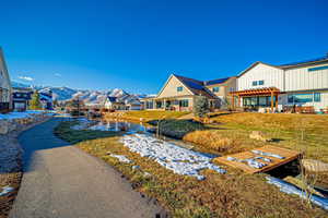 Exterior space with a lawn, a mountain view, and a pergola