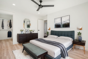 Bedroom featuring ceiling fan and light hardwood / wood-style flooring