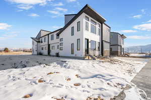 View of snow covered exterior featuring a mountain view