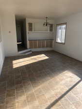 Empty room featuring an inviting chandelier