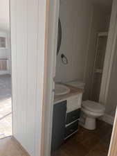 Bathroom with tile patterned flooring, vanity, and toilet