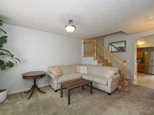 Living room featuring light carpet