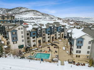 Snowy aerial view featuring a mountain view