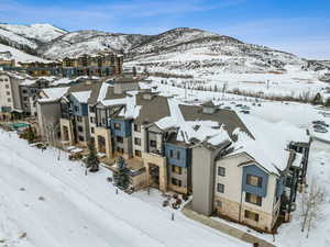 Snowy aerial view featuring a mountain view