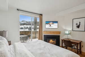 Bedroom with wood-type flooring and a mountain view