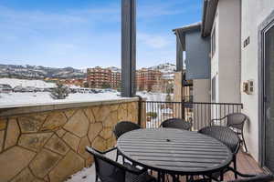 Snow covered back of property with a mountain view