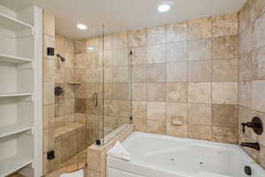 Bathroom with built in features and shower with separate bathtub