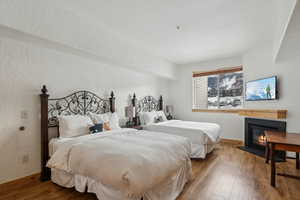 Bedroom with hardwood / wood-style flooring