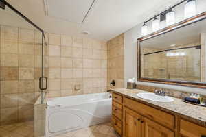 Bathroom with vanity, shower with separate bathtub, and tile patterned flooring