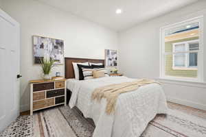 Bedroom with light hardwood / wood-style flooring