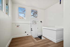 Laundry room with electric dryer hookup, washer hookup, and hardwood / wood-style flooring