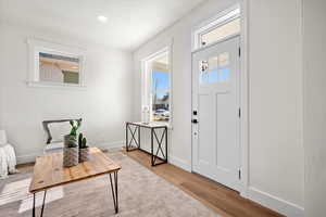 Entrance foyer featuring a wealth of natural light and light hardwood / wood-style flooring