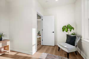 Sitting room with light hardwood / wood-style floors