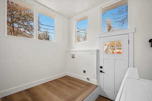 Laundry room with hardwood / wood-style floors, hookup for a washing machine, and hookup for an electric dryer