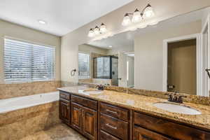 Bathroom with vanity and shower with separate bathtub